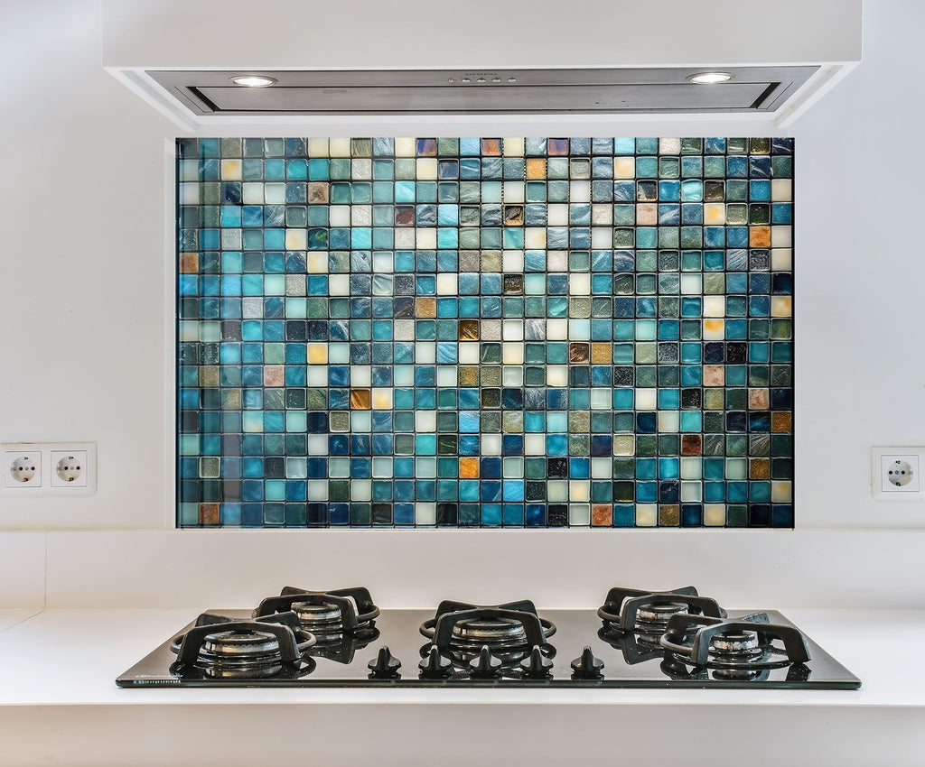 a kitchen with a stove top and a tiled wall