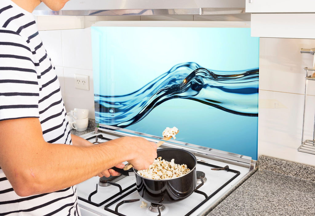 a man is cooking popcorn on the stove