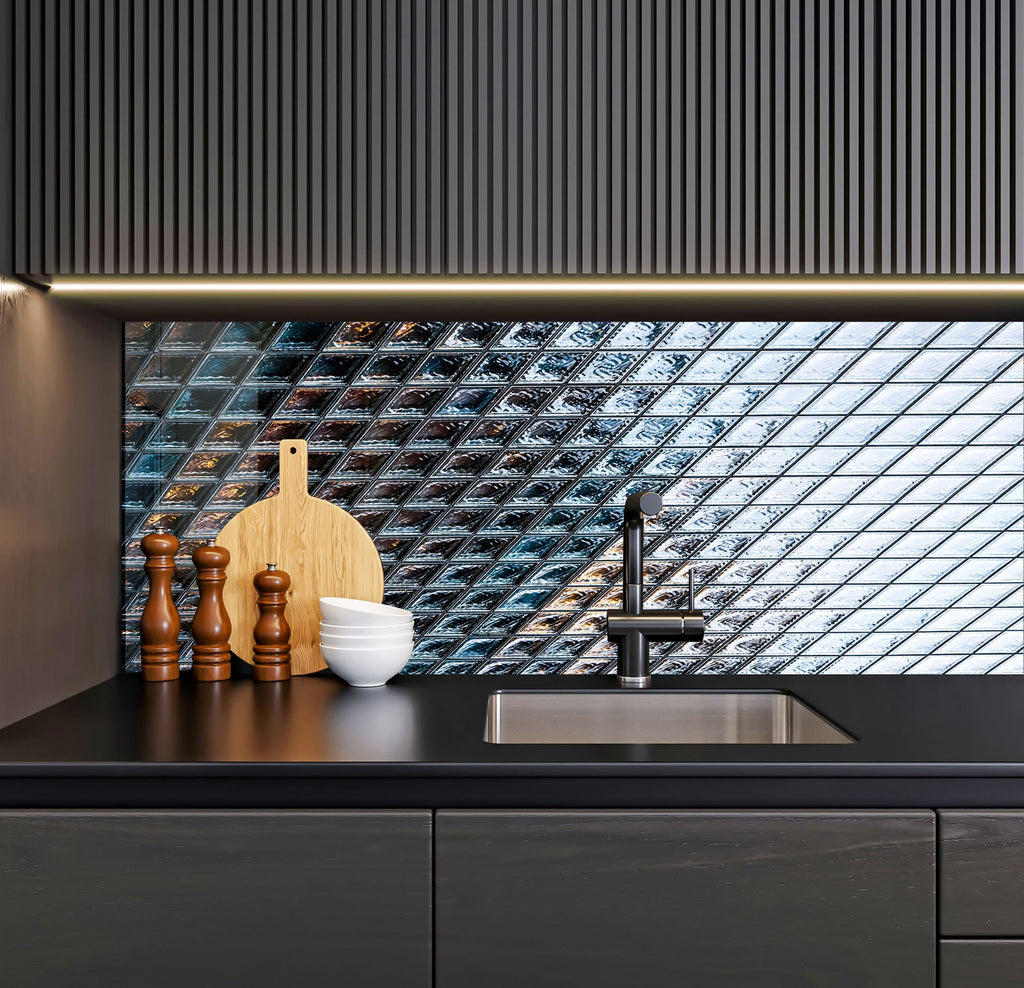 a kitchen with a black counter top and a wooden cutting board