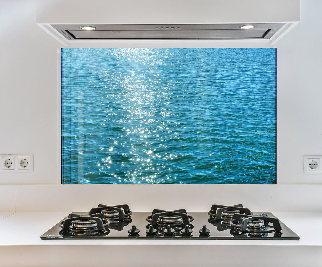 a stove top with a picture of a body of water behind it