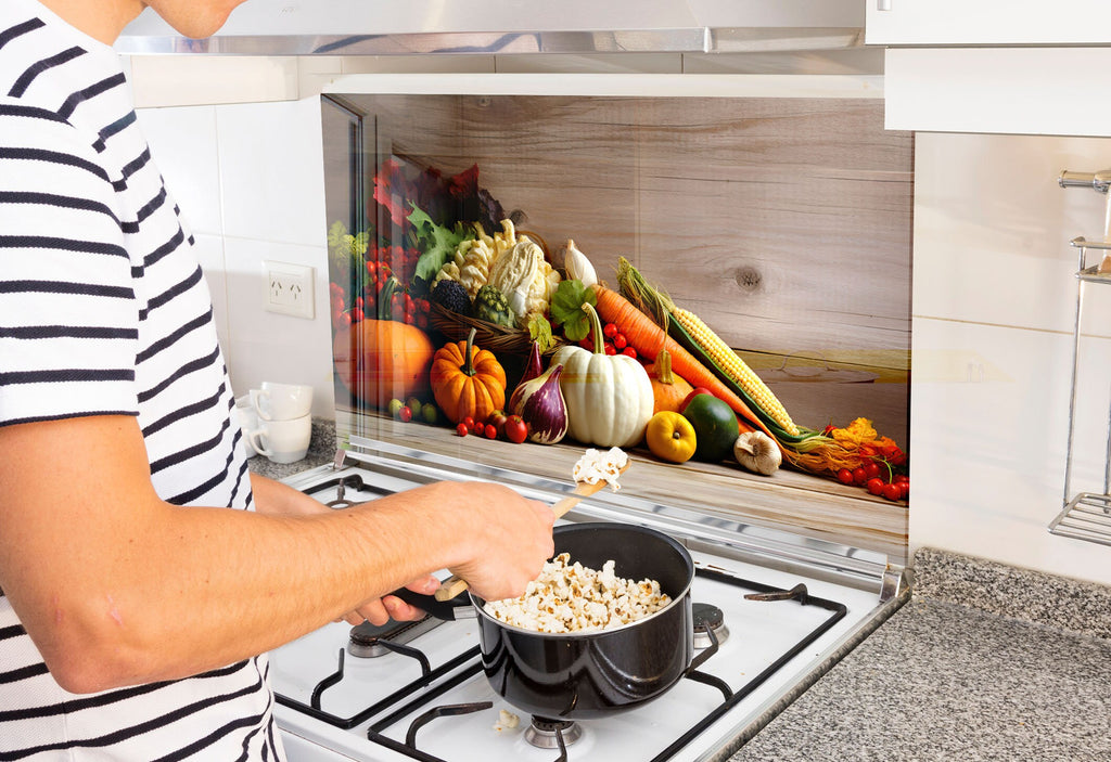 a man cooking food in a pot on the stove