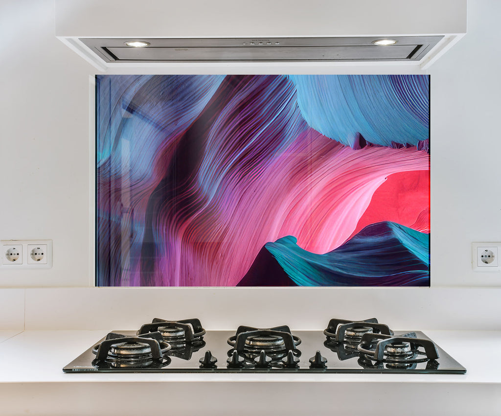 a stove top with a painting on the wall above it