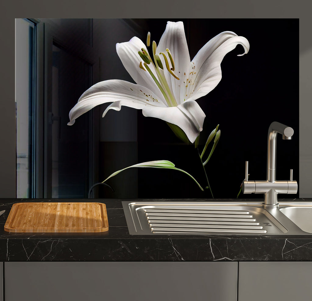 a white flower sitting on top of a counter next to a sink