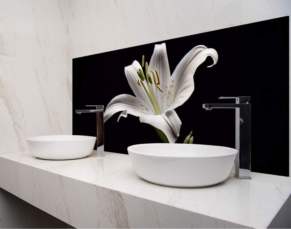 a bathroom with two sinks and a large white flower